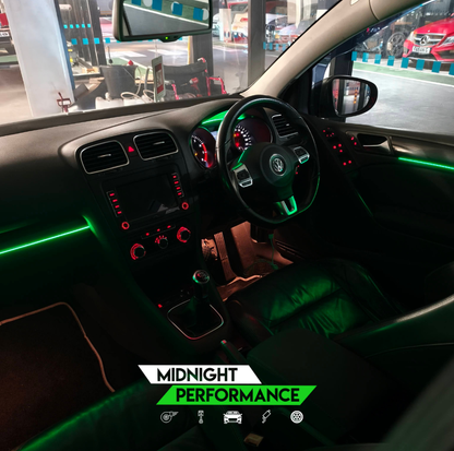 Car interior with neon lights and 'Midnight Performance' text