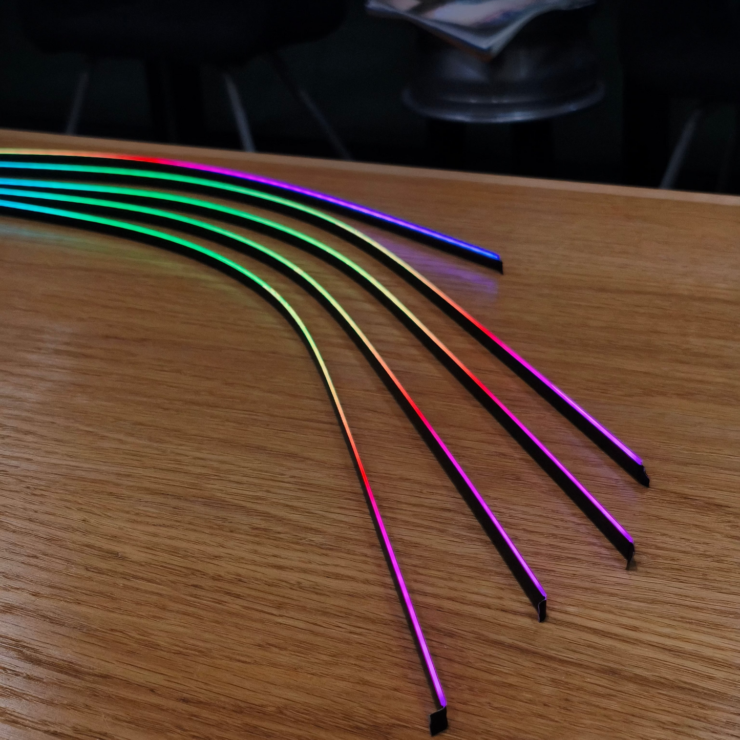 Colorful LED strip lights on a wooden surface